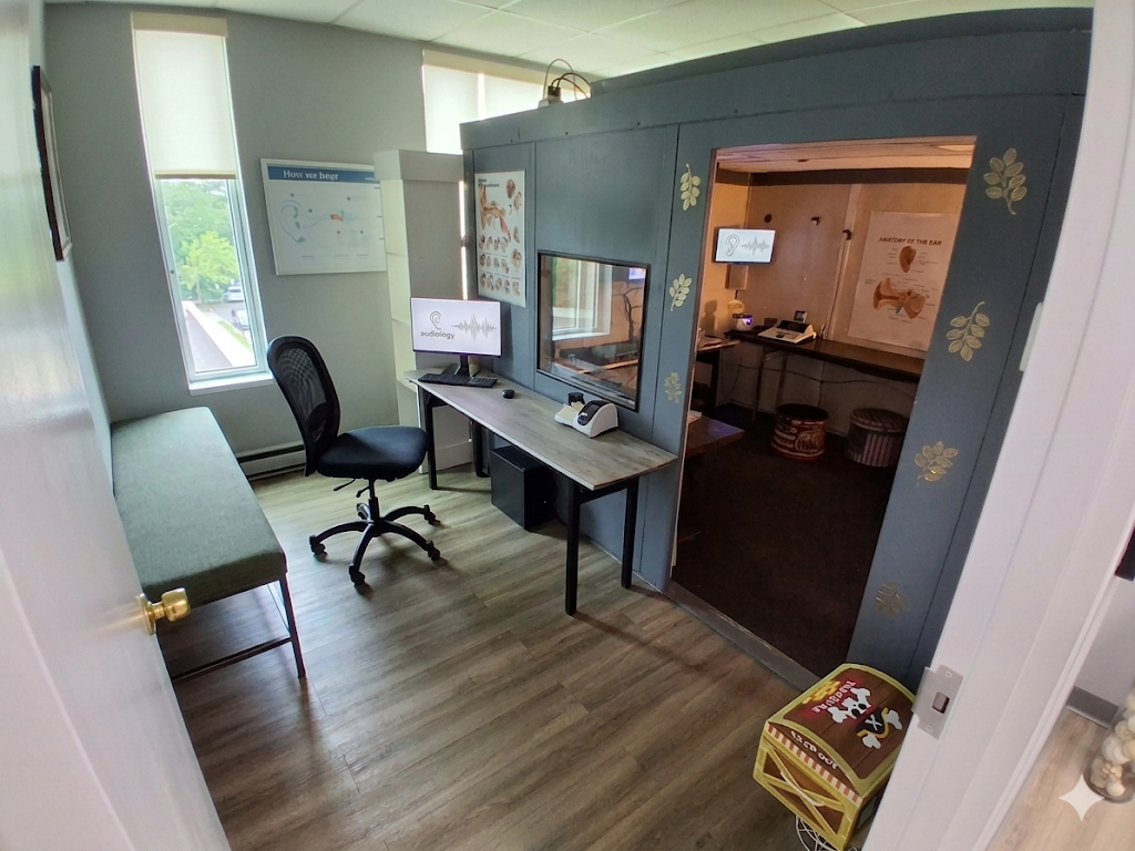 Pediatric hearing test room with colorful wall decals and sound booth